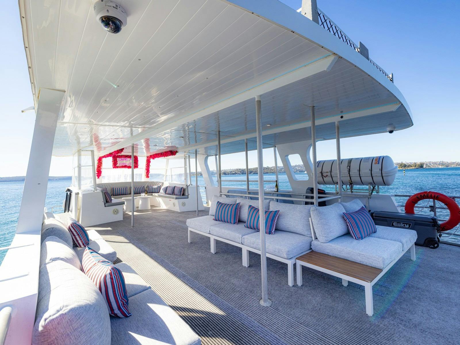 Upper deck lounge on Capri on Emelie with wraparound seating and red floral styling
