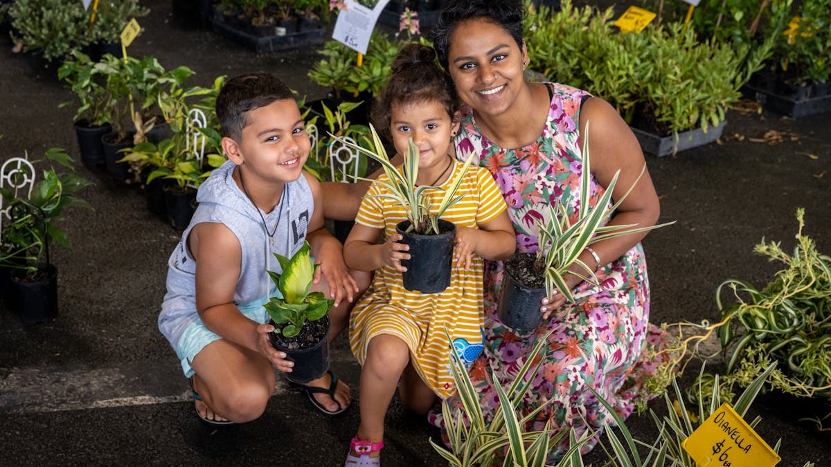 Mother and children with plants