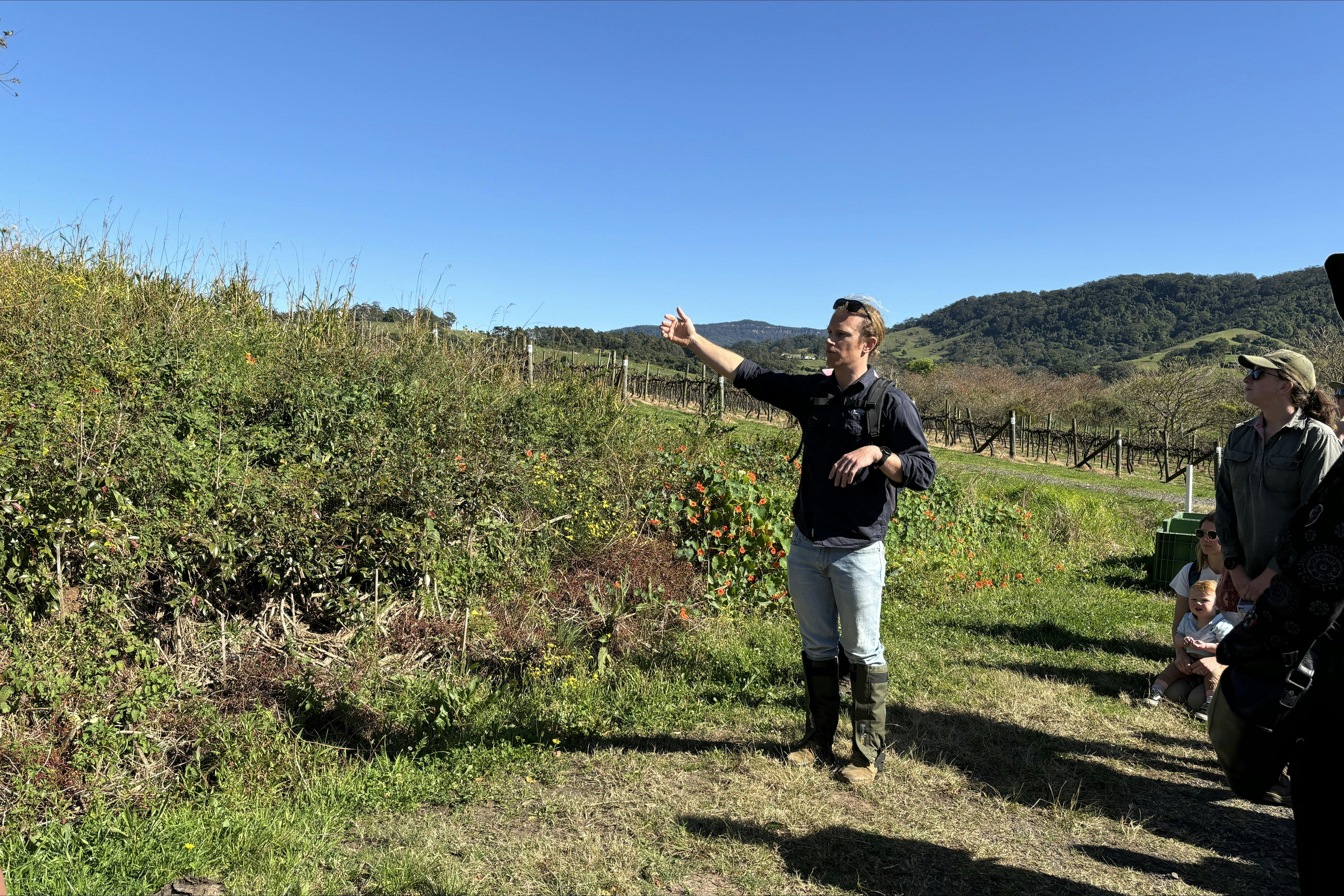 Nature Walk host explaining a project site to past attendees