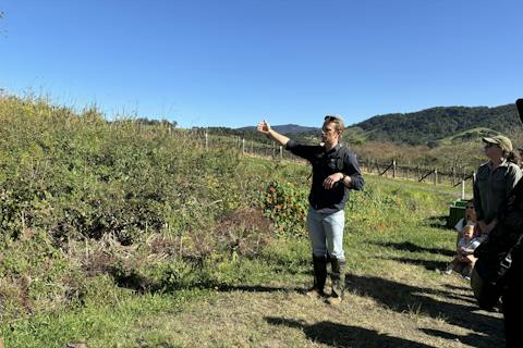 Nature Walk host explaining a project site to past attendees