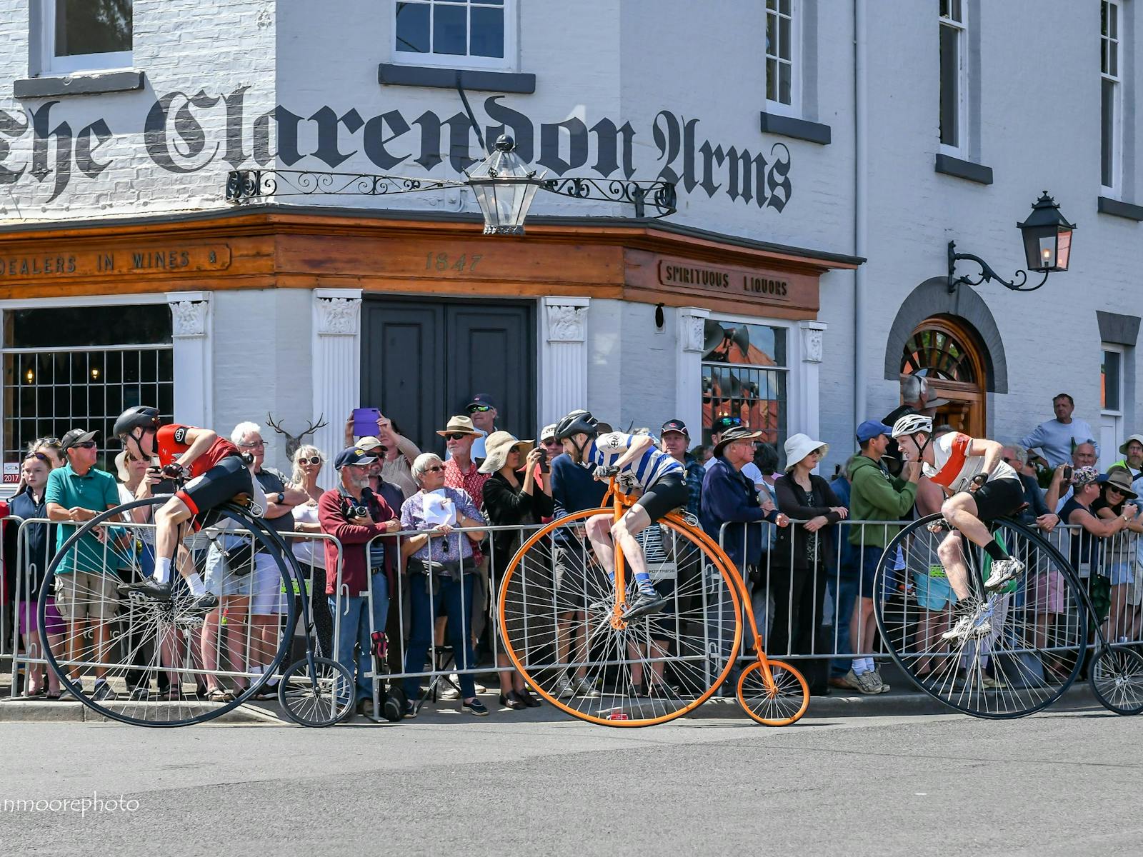 National Penny Farthing Championship riders race around the corner of The Clarendon Arms