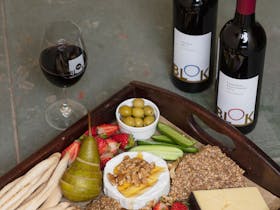 two bottles of wine and a cheese board