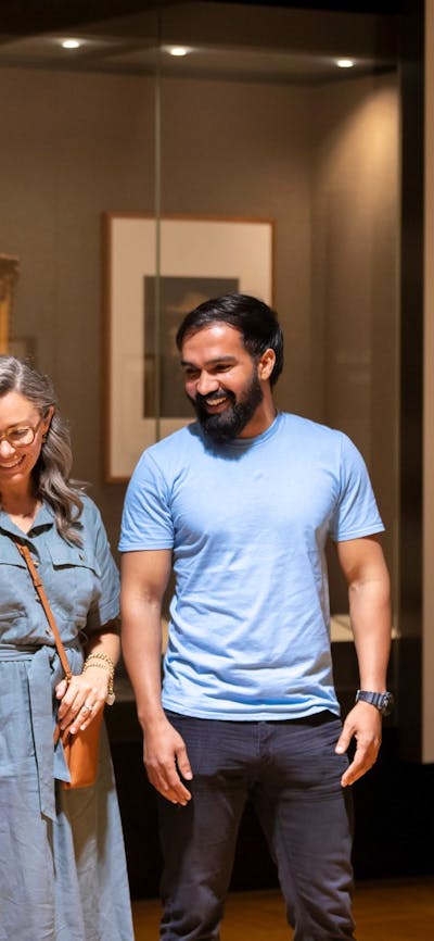 A man, woman and young girl in the Treasures Gallery at the National Library of Australia