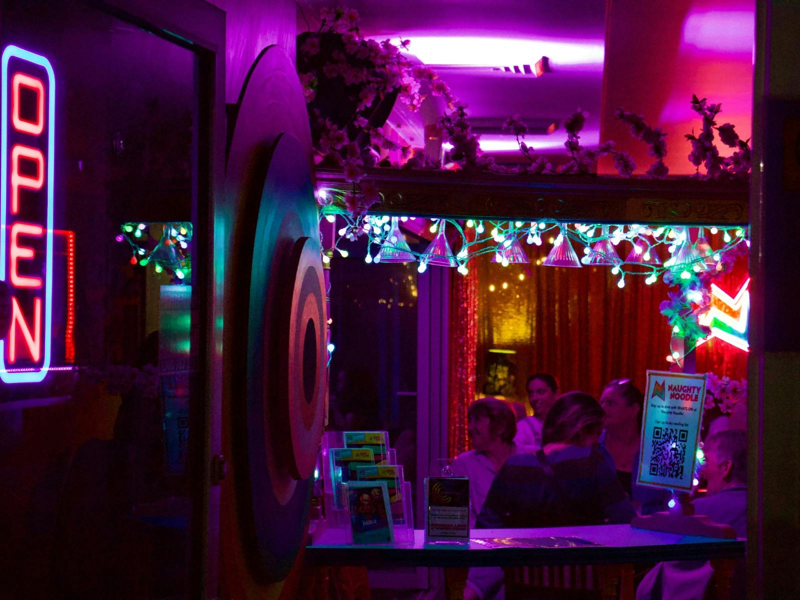 An image of the entry with an open sign lit up