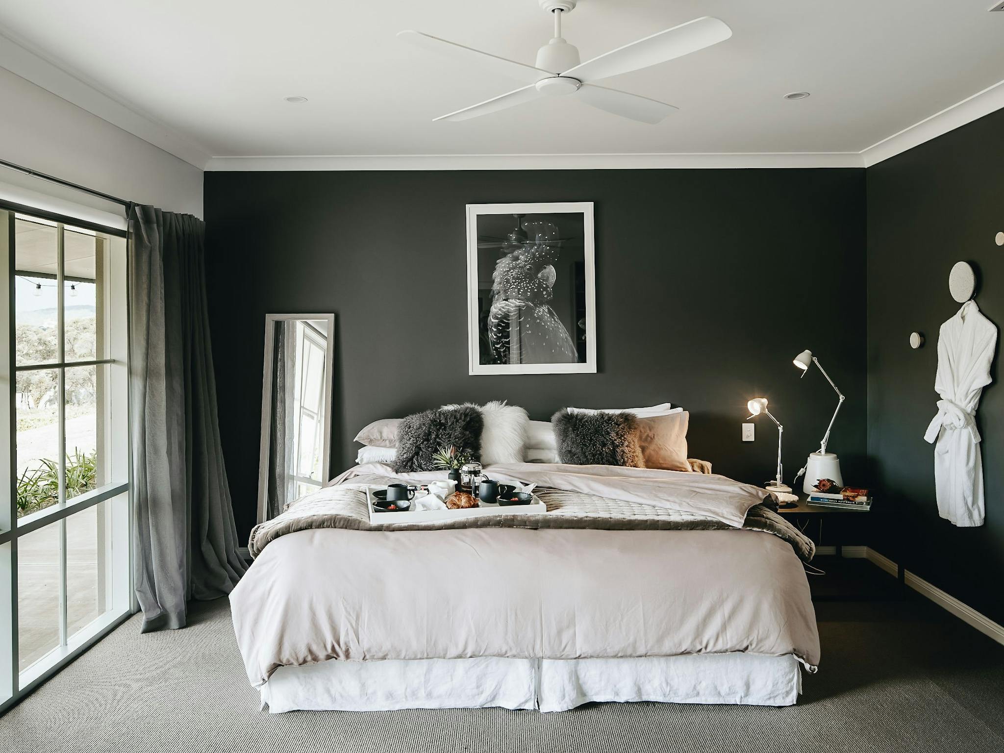 Luxurious moody bedroom with breakfast platter