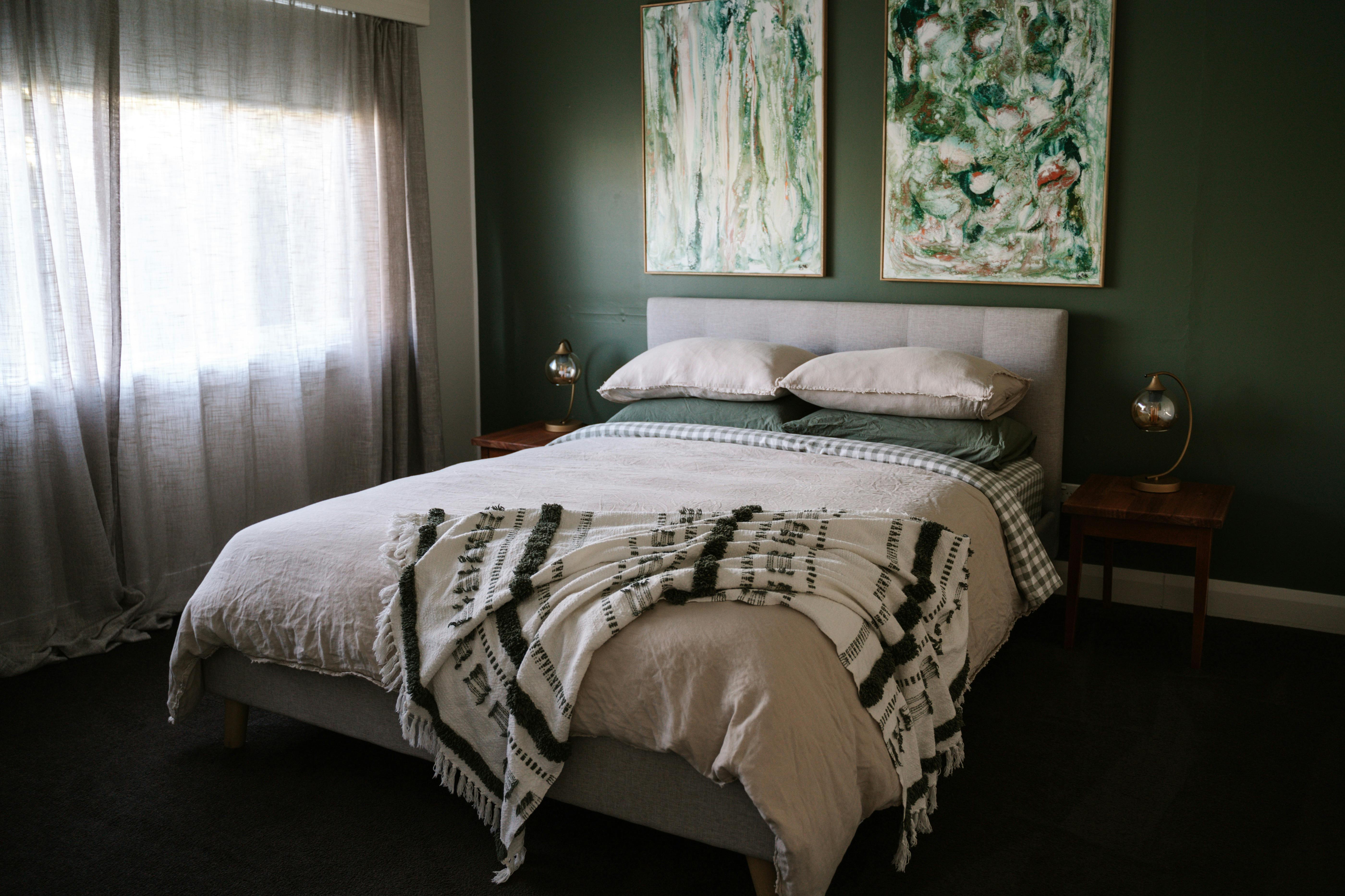 Soothing green and natural tones in this bedroom with amply storage.