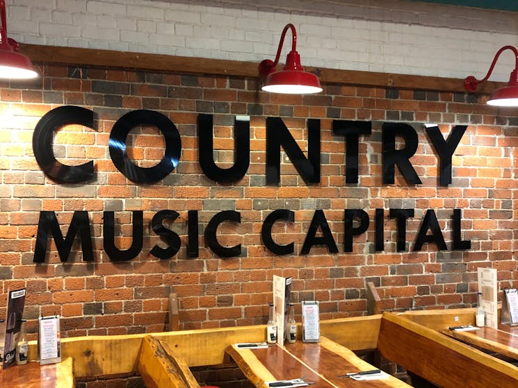 Black sign saying Country Music Capital is in the restaurant. Great sign to have your photo with.
