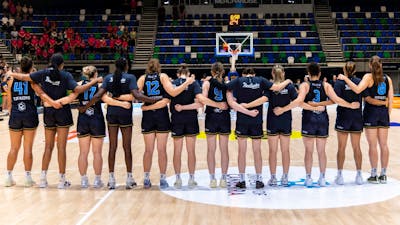 UC Capitals stand in a line after their names are called before the start of a game.