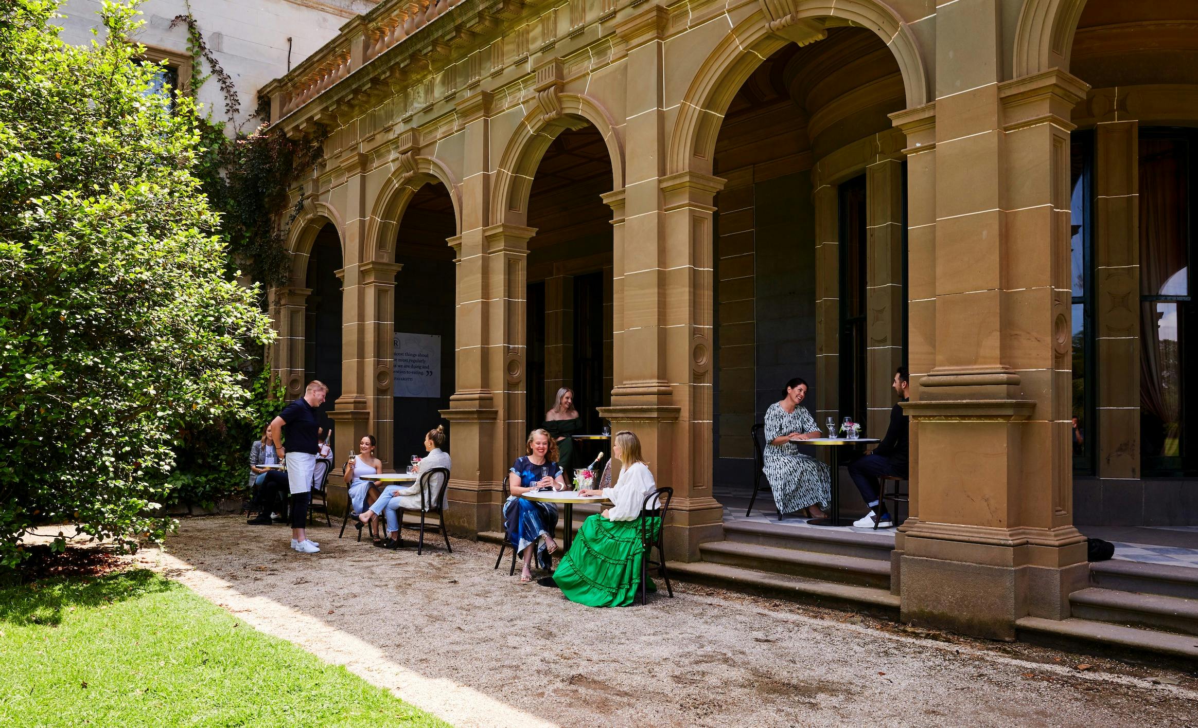 People enjoying al-a-cart menu dining under the eaves of The Refectory at Werribee Mansion
