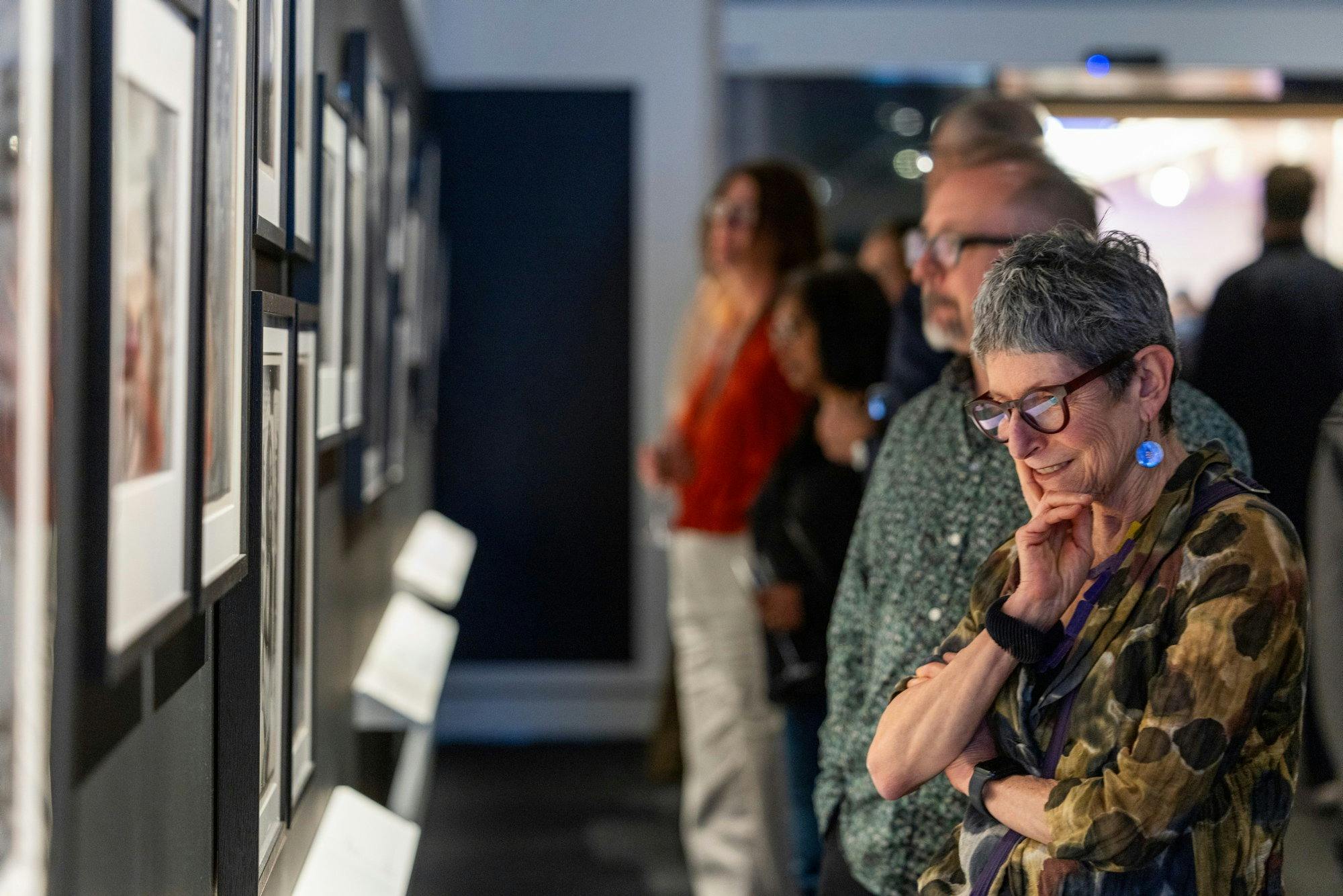 People looking at photographs in an exhibition