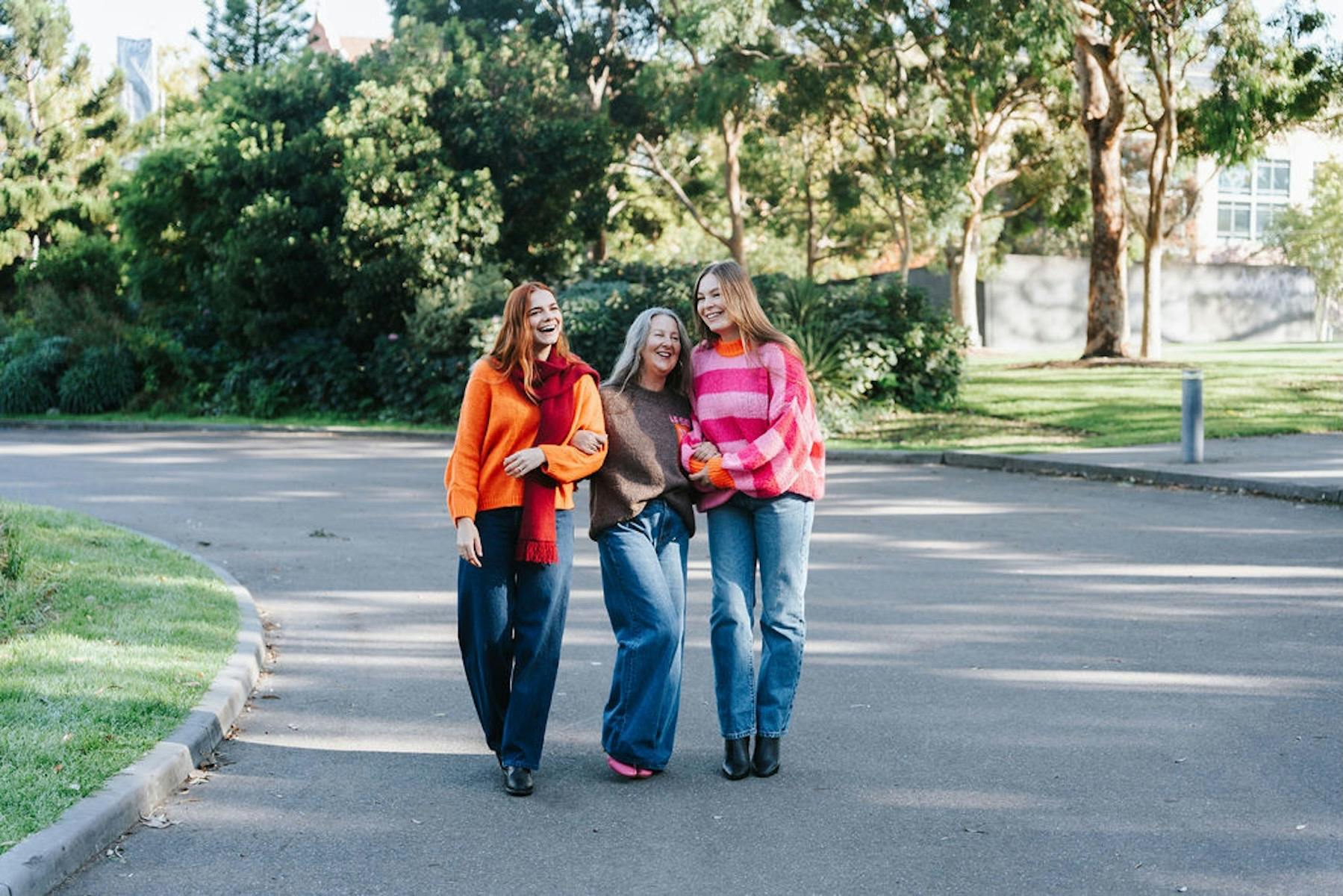 Three women wearing winter jumpers