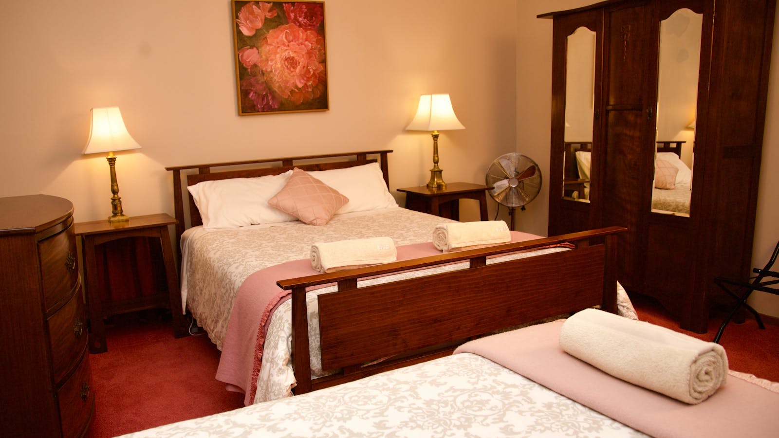 Suite 1 offers a single bedroom containing a queen and a single bed.