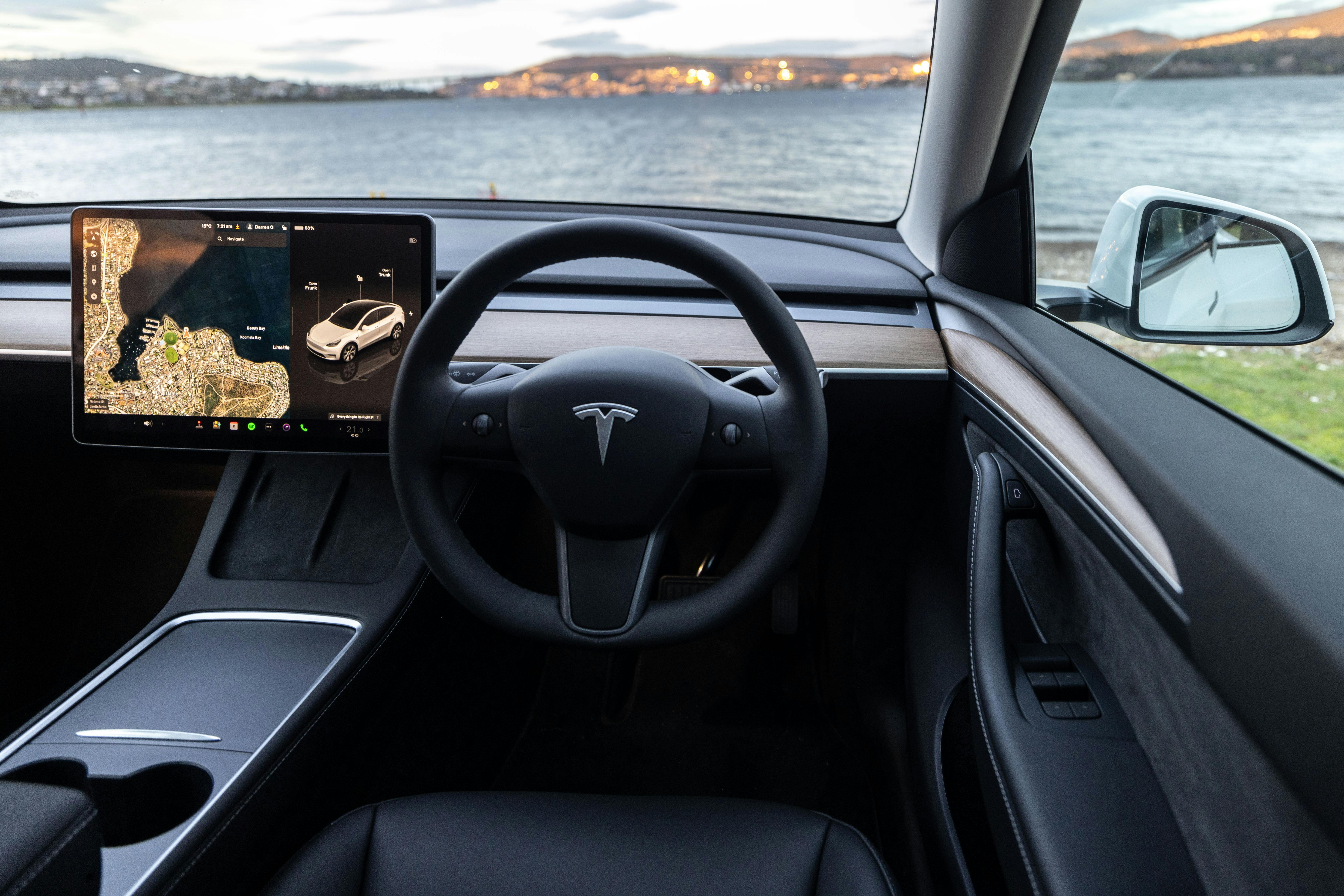 Electric Vehicle hire car (Tesla Model Y) interior, parked on the Derwent River in Tasmania.