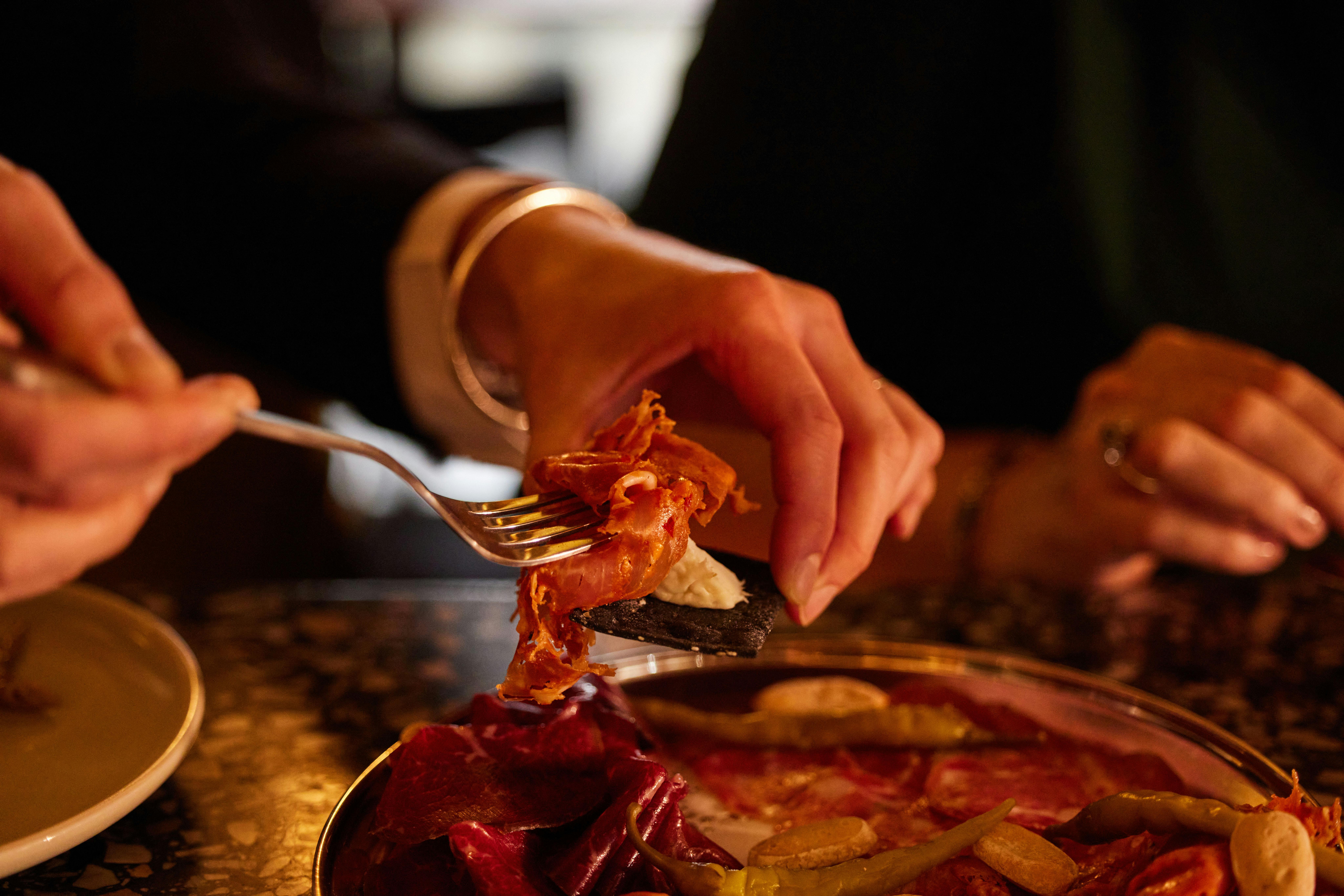 Guest spoons up food onto plate