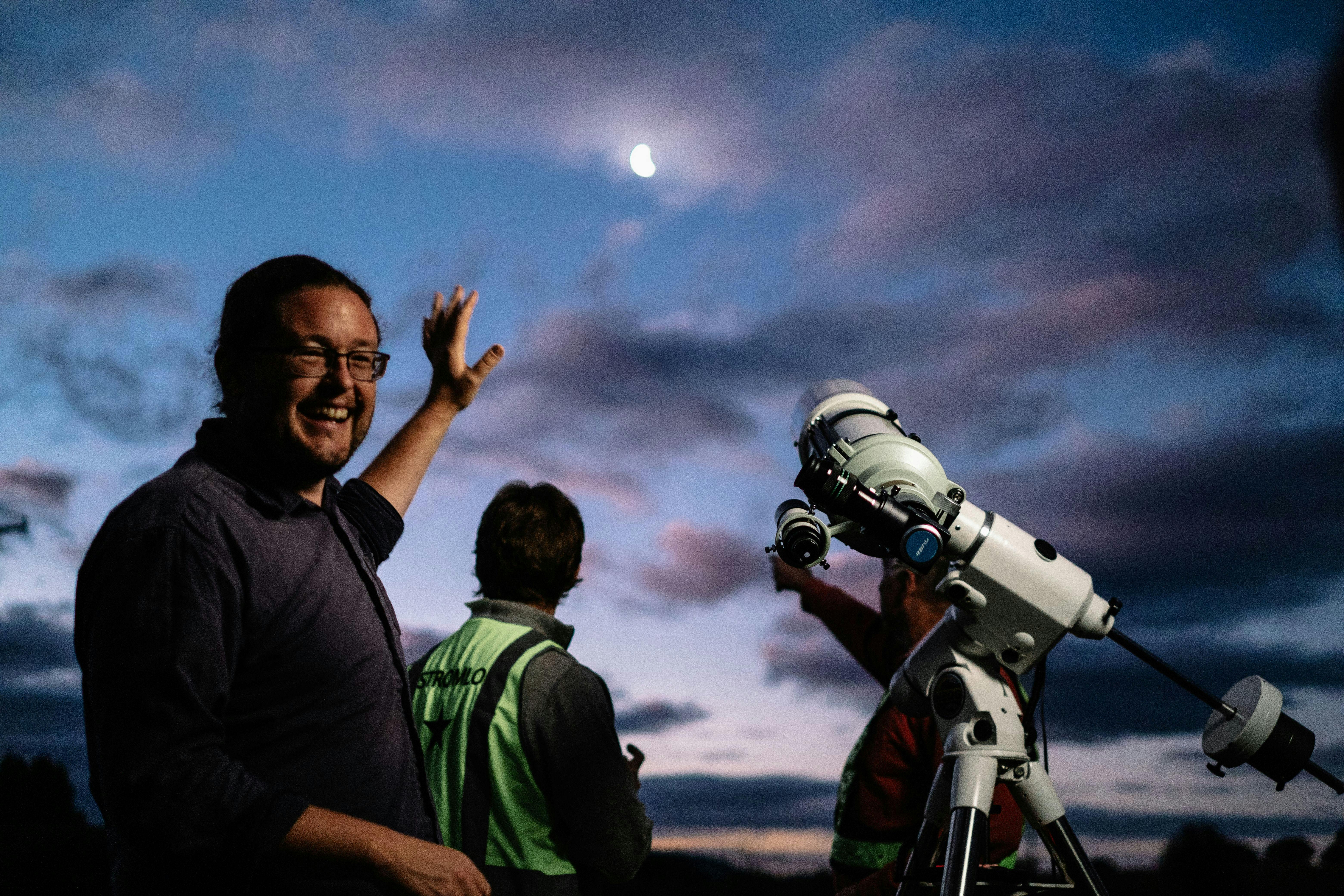 Man next to telescope describes something about night sky at Lanyon Homestead