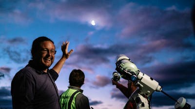 Man next to telescope describes something about night sky at Lanyon Homestead