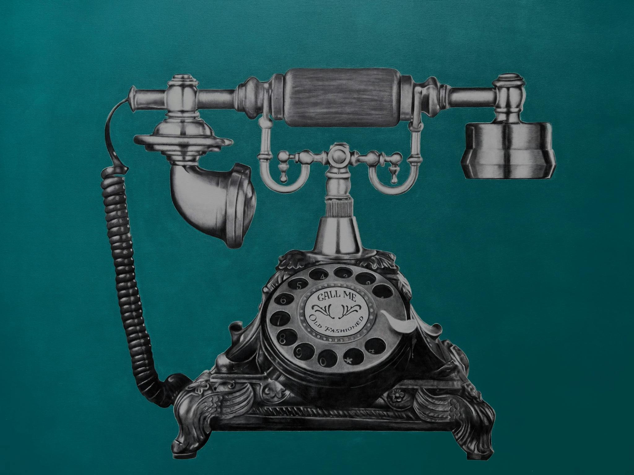 Cradle vintage telephone on teal background with quirky message