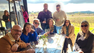 Group photo at the Vintner's Daughter with the vineyard in the background