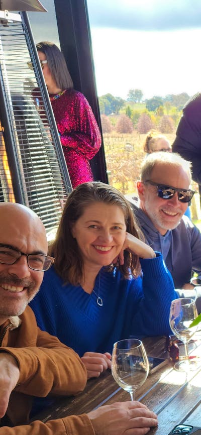 Group photo at the Vintner's Daughter with the vineyard in the background