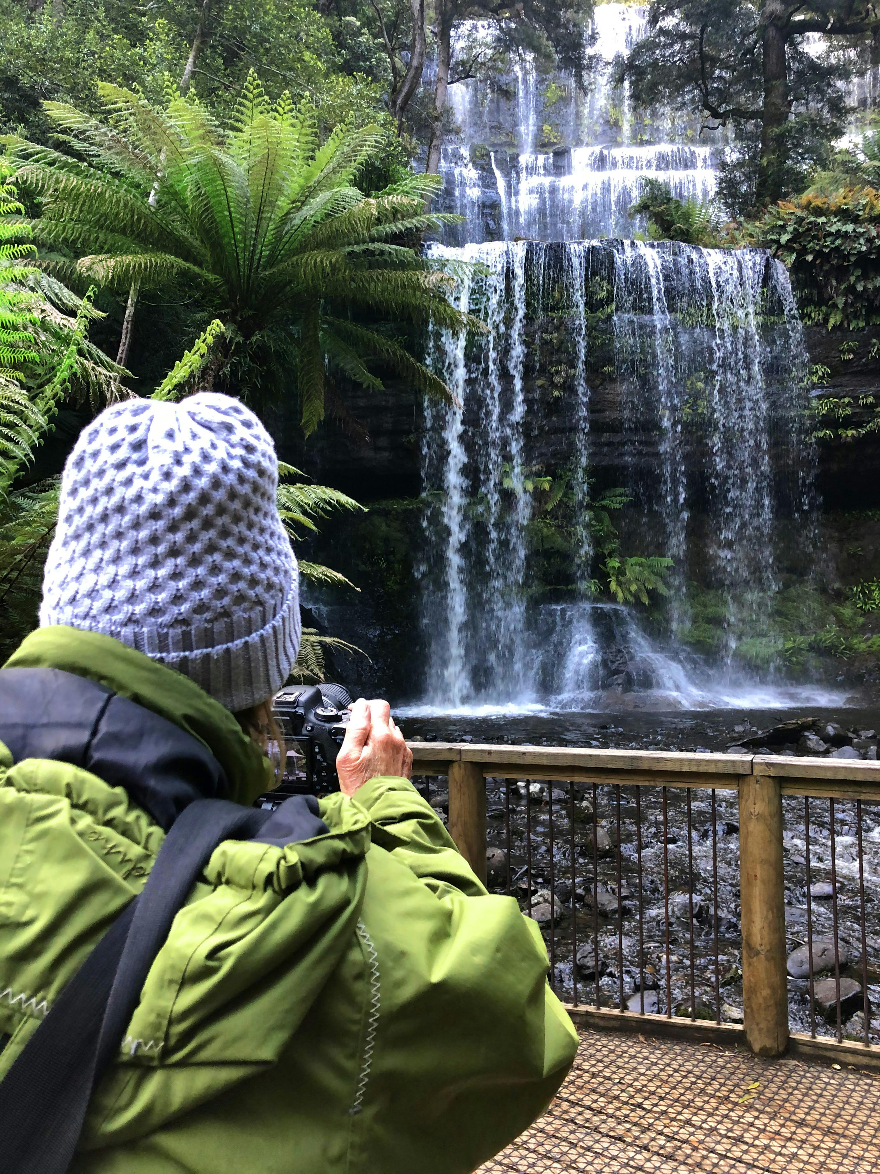 tourist taking photos of Russell Falls