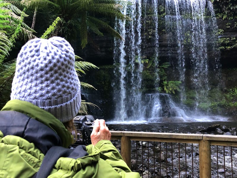 tourist taking photos of Russell Falls