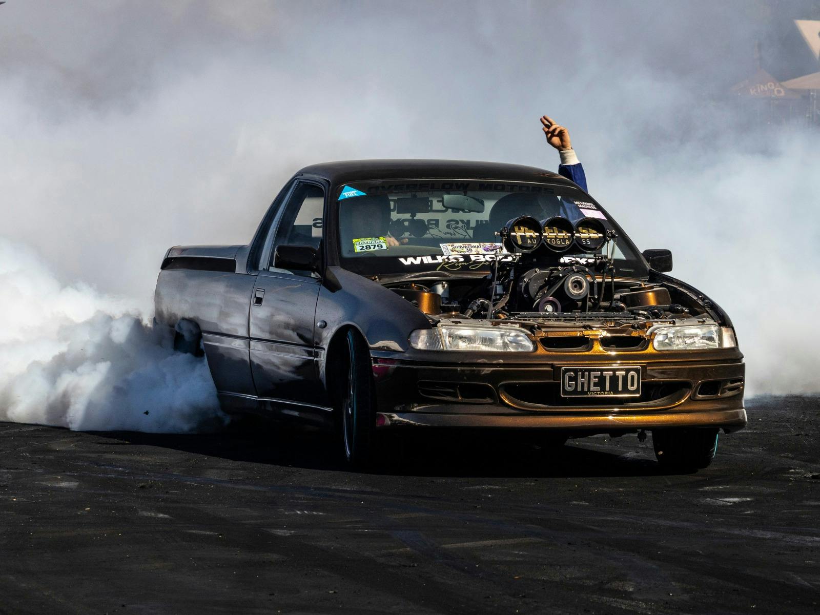 Supercharged burnout ute GHETTO surrounded by tyre smoke during a burnout.