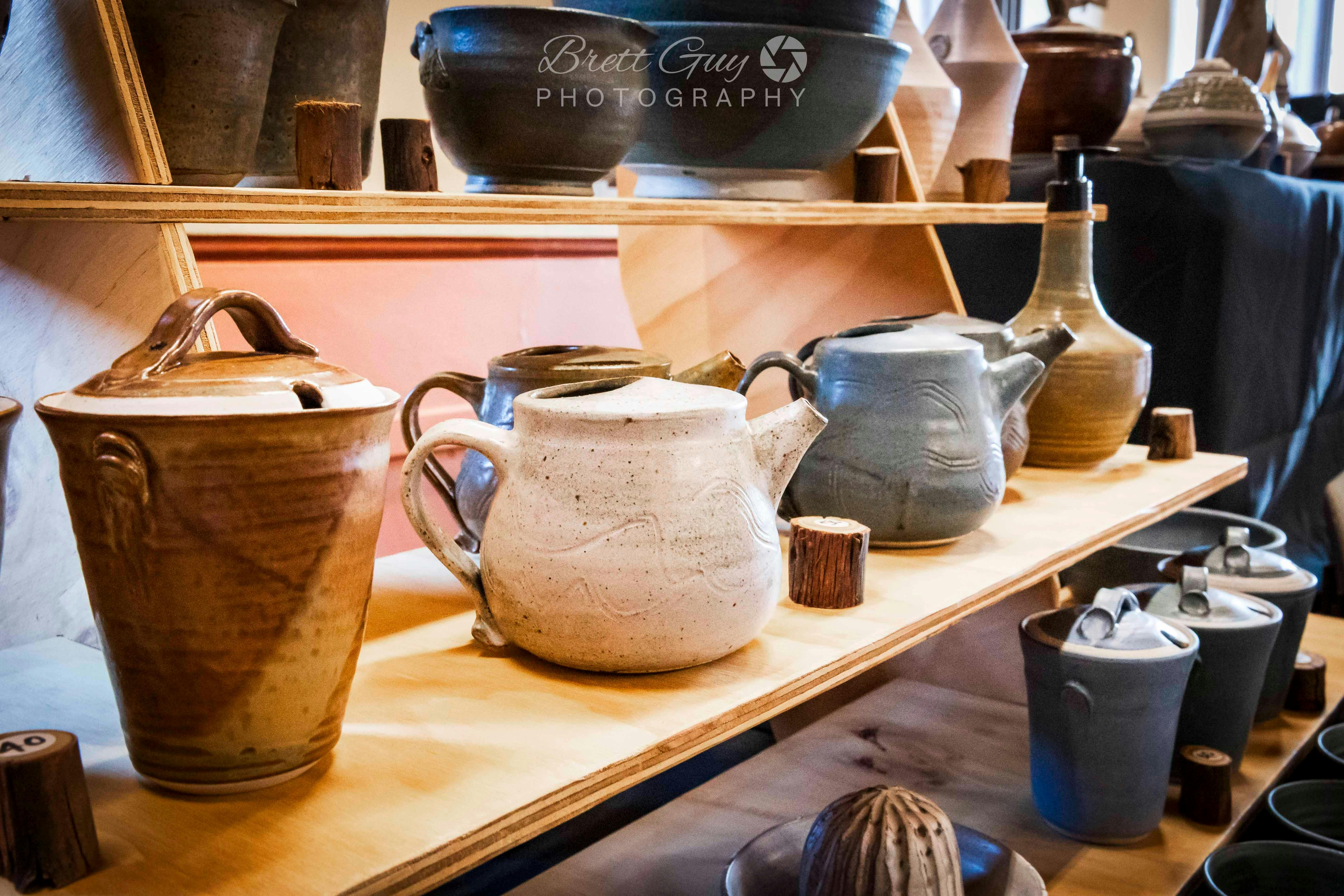 various shaped ceramic pots displayed on a shelf