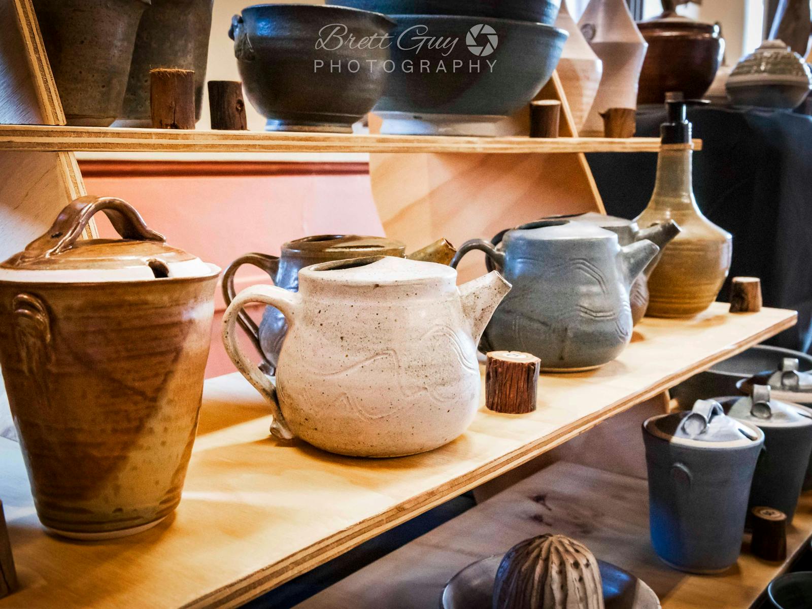 various shaped ceramic pots displayed on a shelf