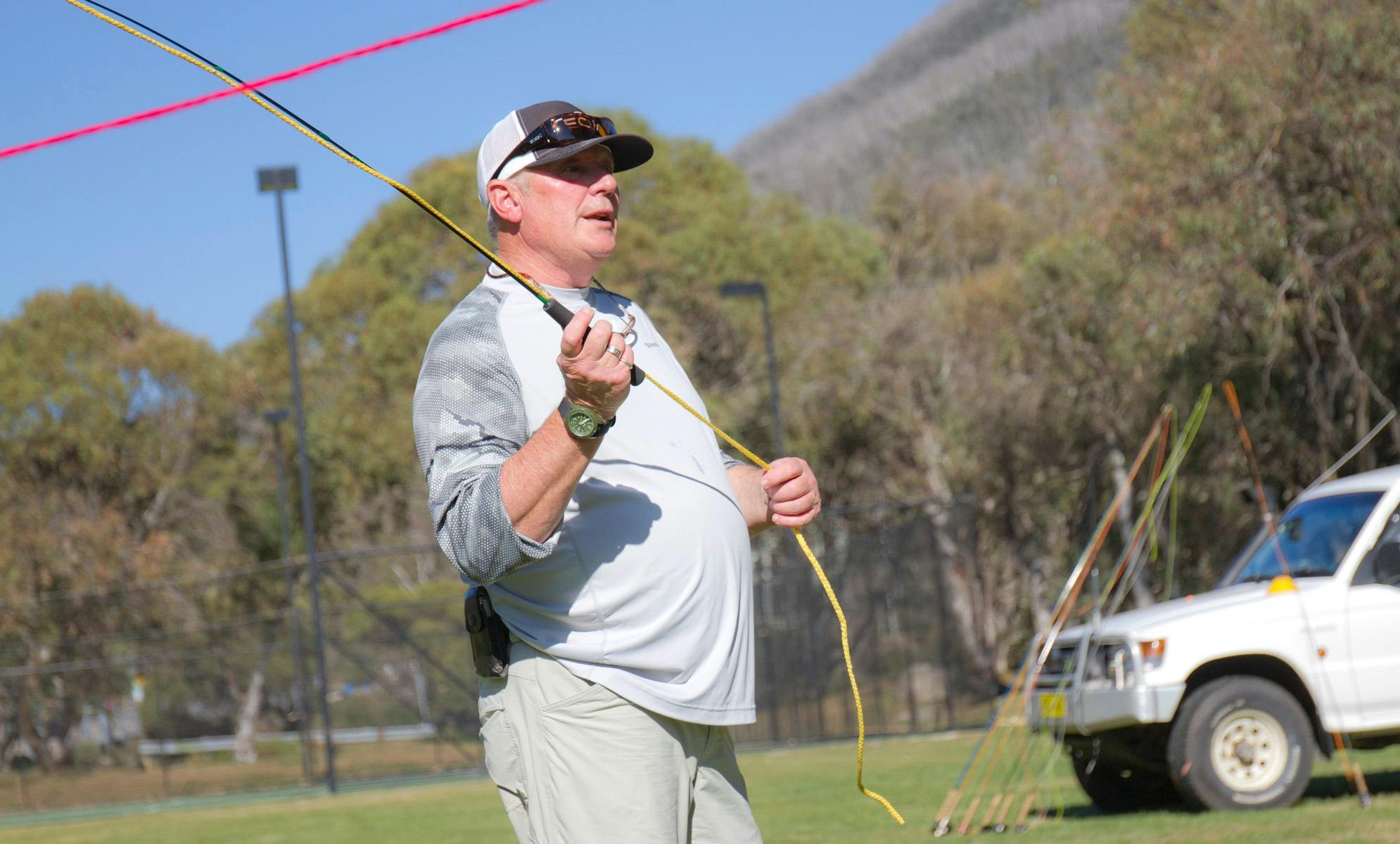 A man swinging a practice fishing rod
