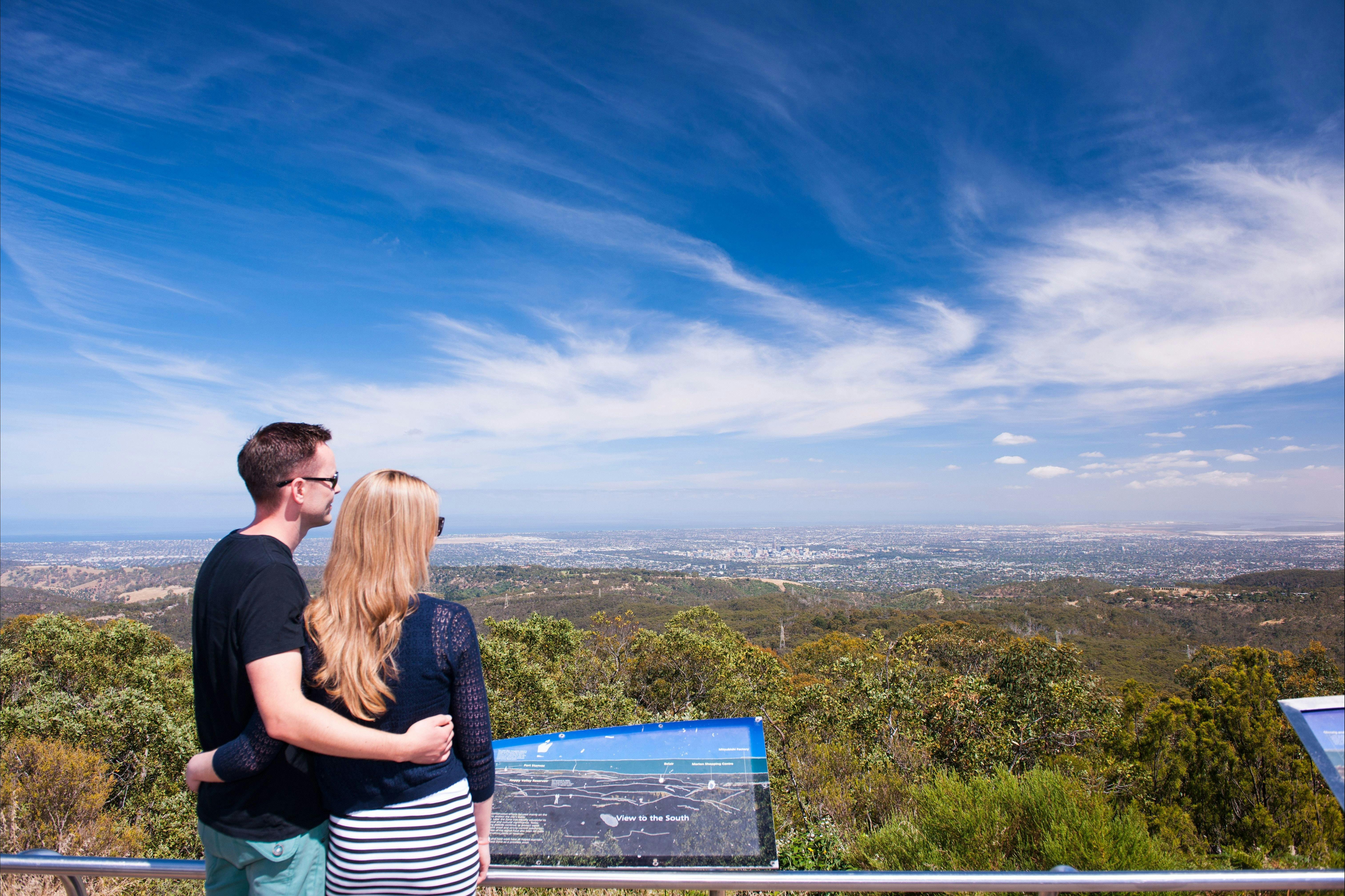 Man and women embracing at the Mount Lofty Summit lookout over Adelaide