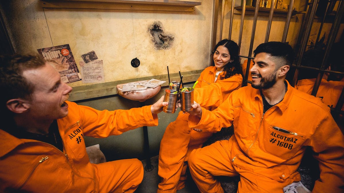Friends cheers a drink within a theatrical space
