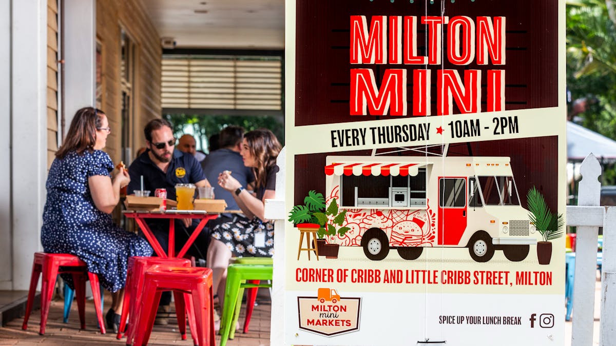 Milton Mini signage with people dining in the background