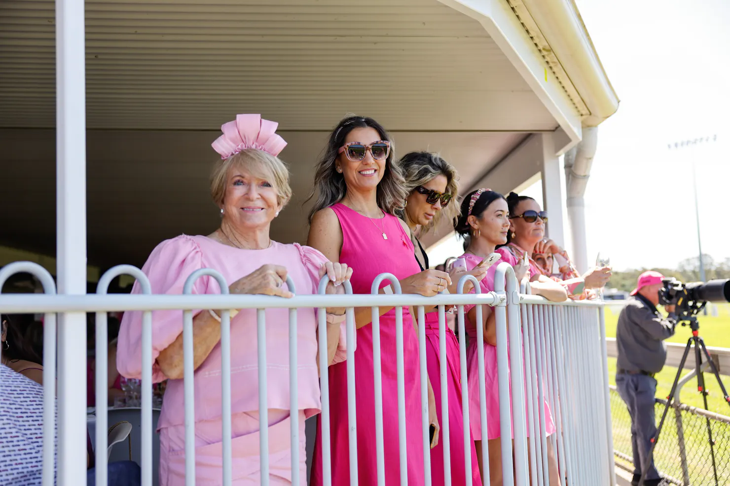 Ladies smiling in the Champagne Garden watching the races