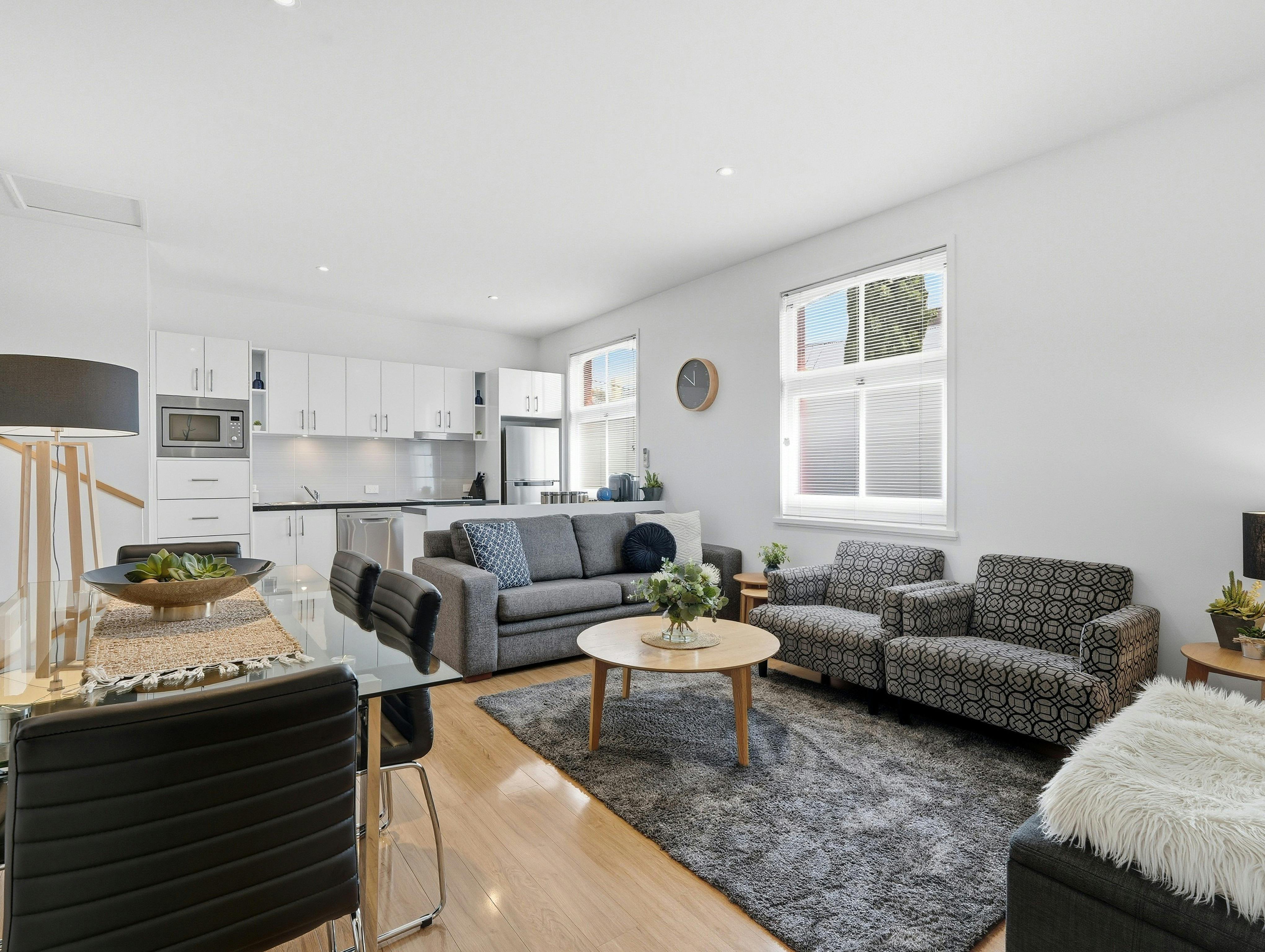 Spacious open-plan living and dining area with comfortable seating and modern kitchen