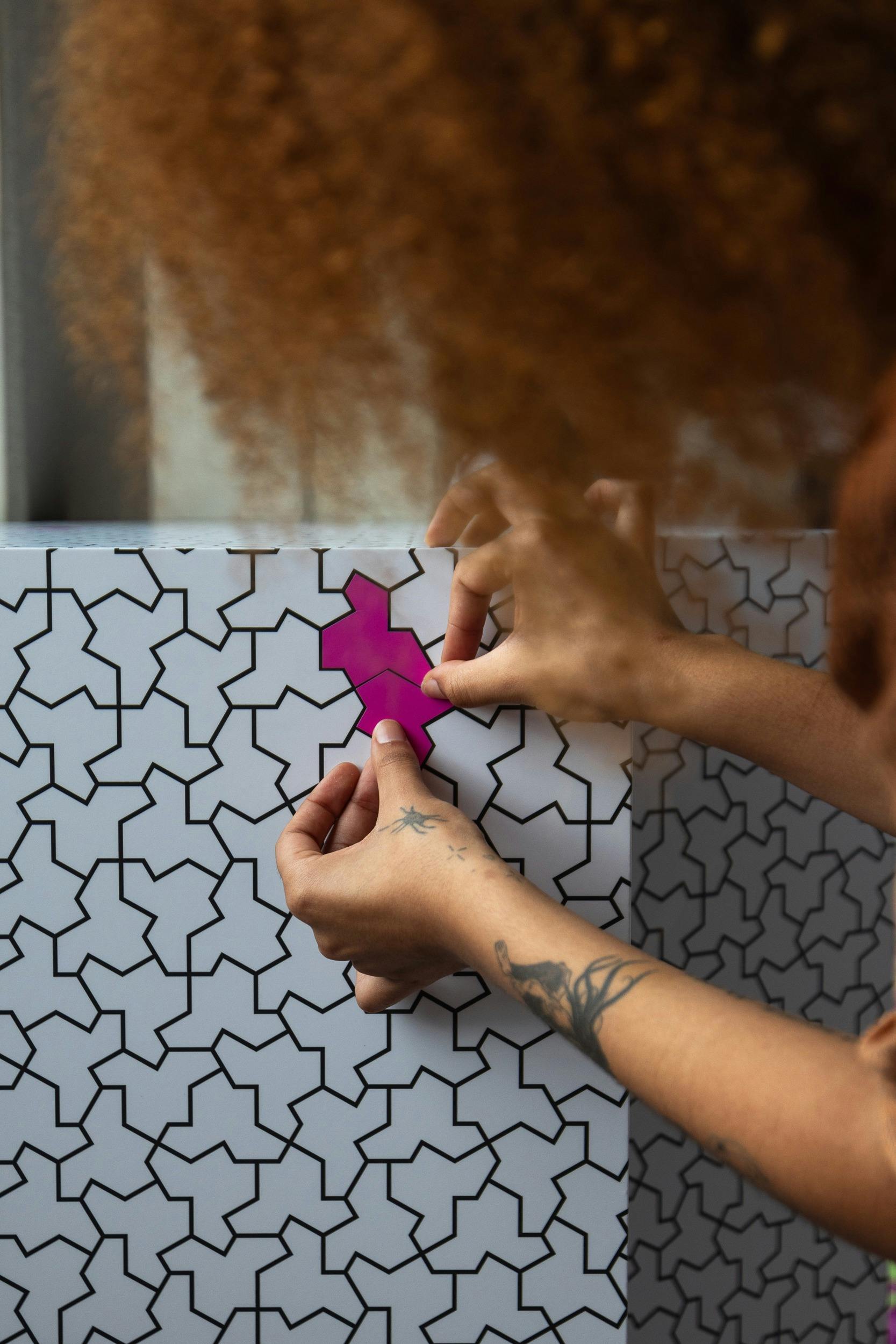 a person placing a sticker on a white block