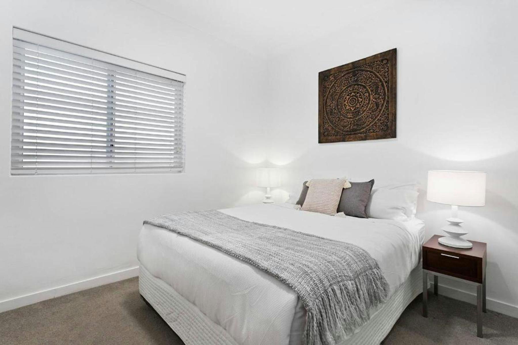 Master bedroom with queen bed and built in wardrobe.