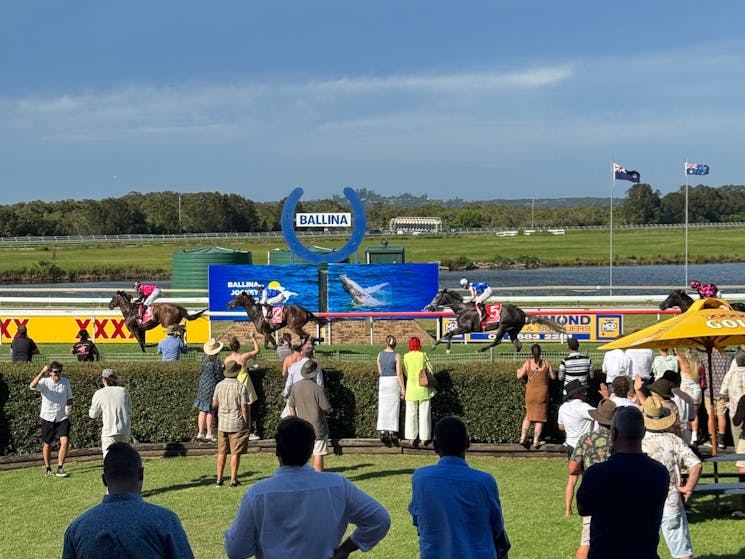 All the excitement of the horses crossing the line in front of the Ballina Winning Post