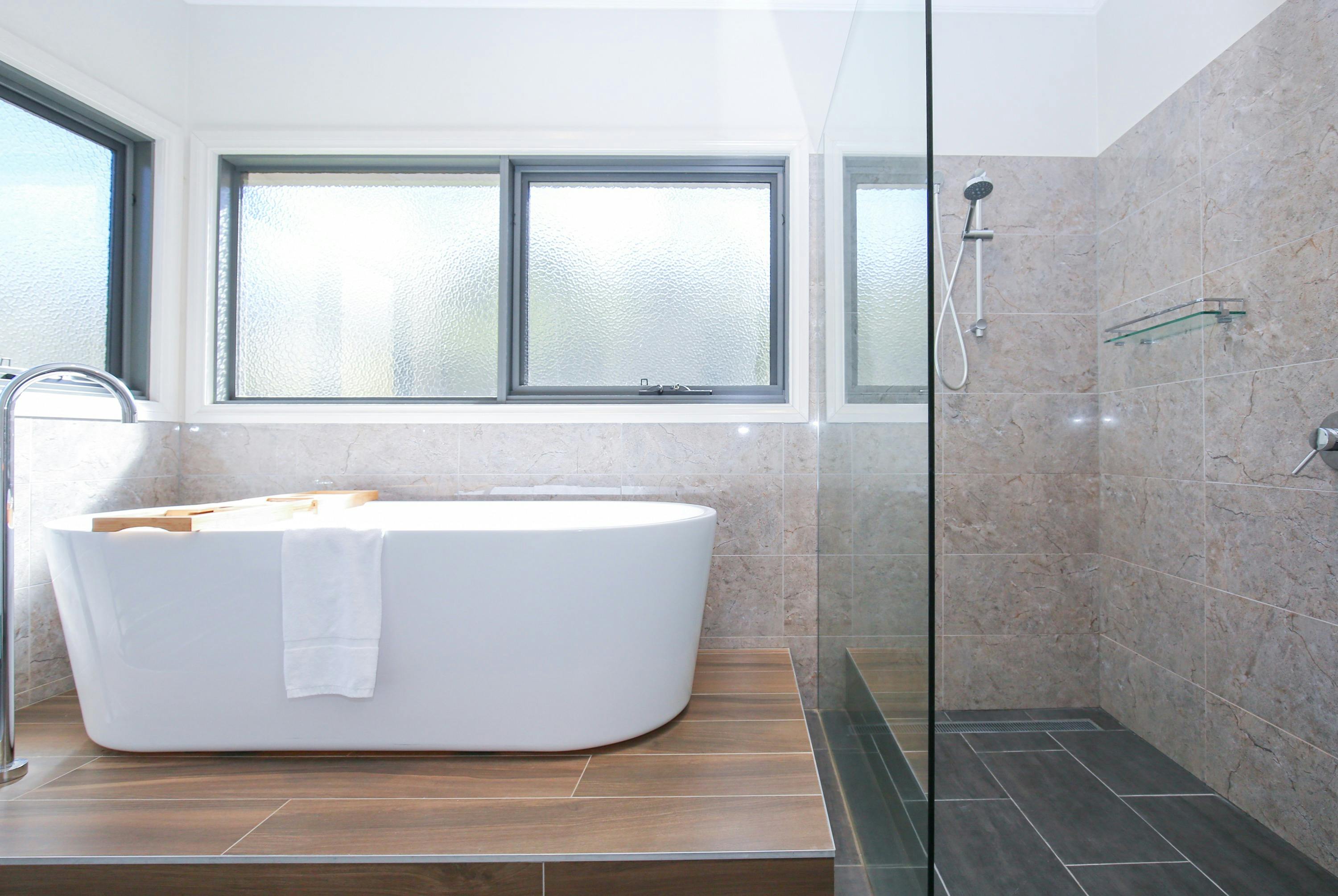 Northern Exposure Bright bathroom featuring shower and bathtub