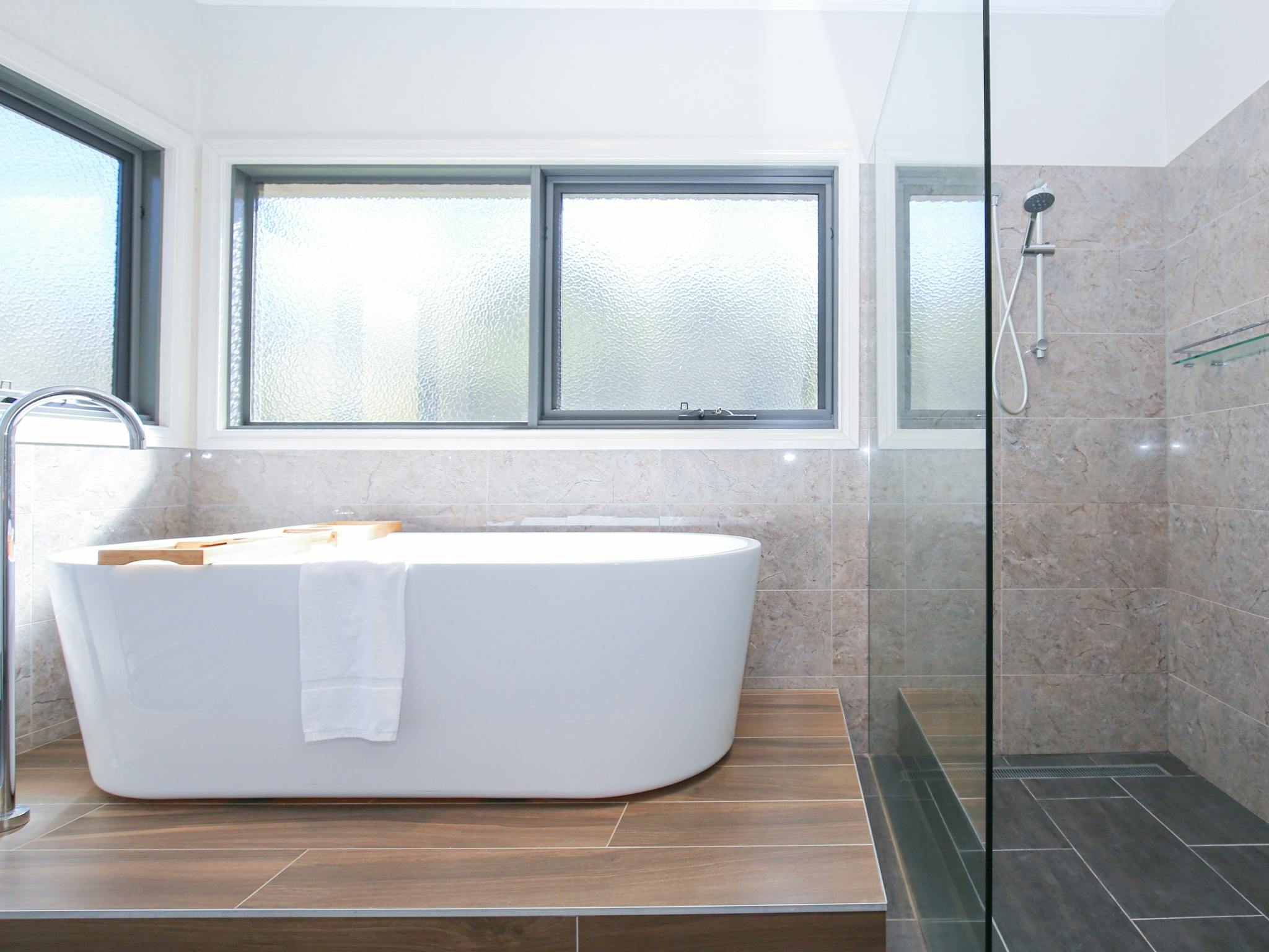 Northern Exposure Bright bathroom featuring shower and bathtub