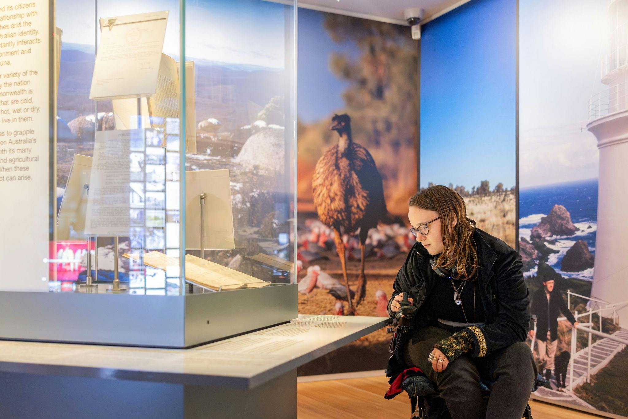 Visitor reading a label in Connections / Mura gadi gallery