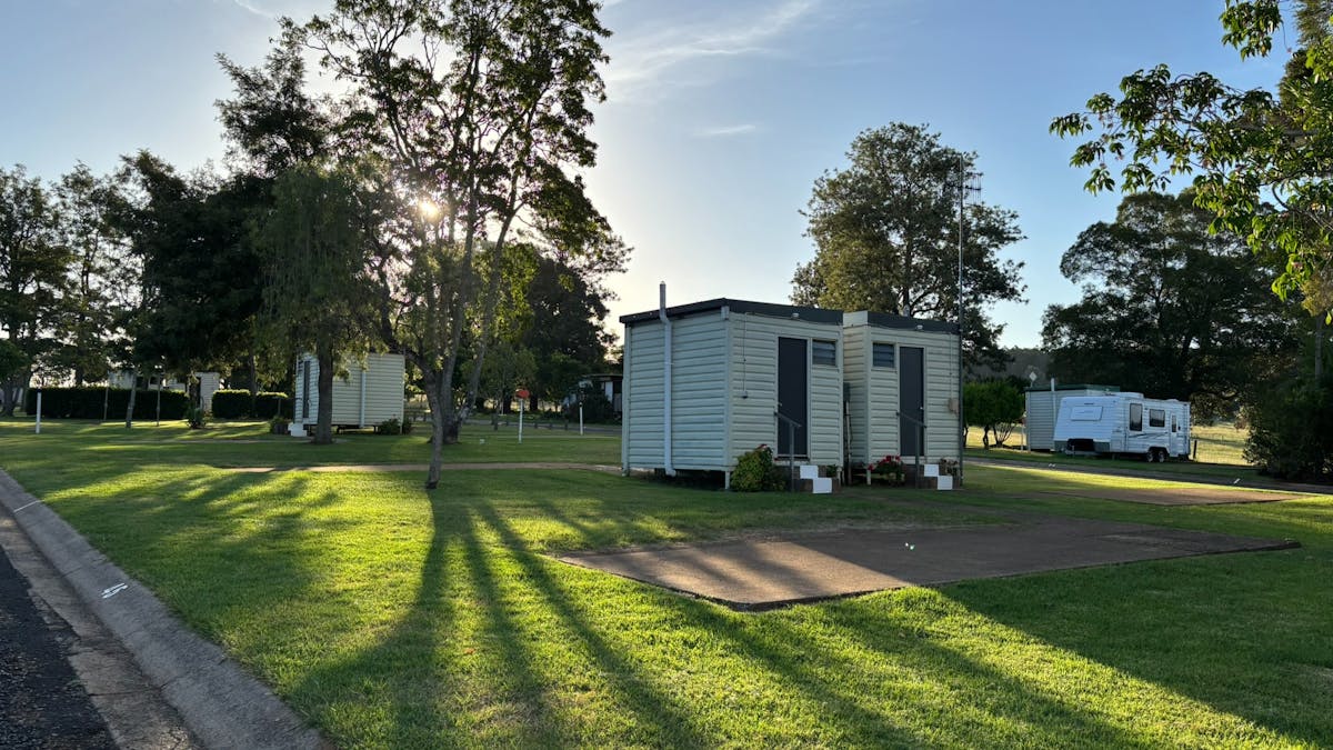 Private ensuite bathroom pods located on grassy powered sites at Yarraman Caravan Park and Cabins.
