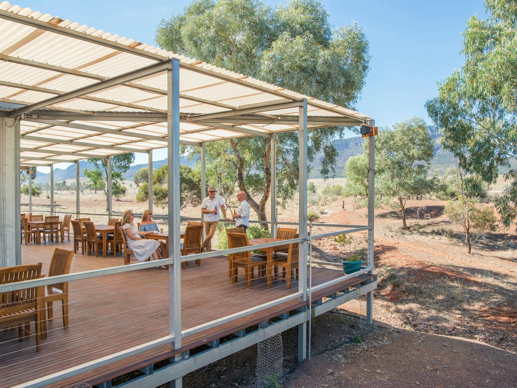 People enjoying afternoon drinks on the deck at the Woolshed Restaurant