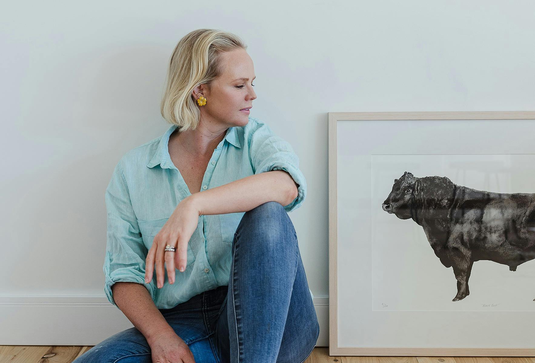 Carina Chambers looks at her 'Black Bull' framed limited edition print featuring an Angus Bull