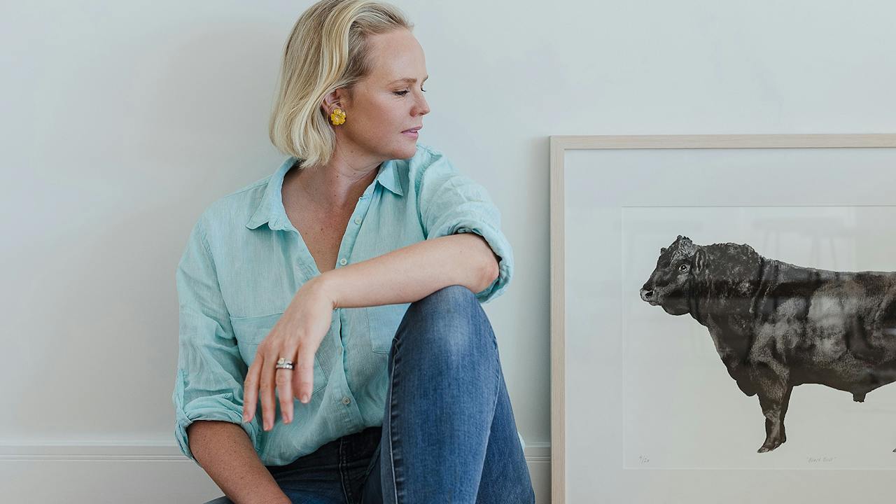 Carina Chambers looks at her 'Black Bull' framed limited edition print featuring an Angus Bull