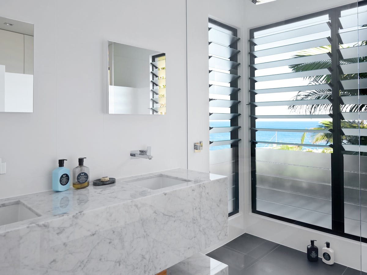 Bathroom beach house features Carrara marble