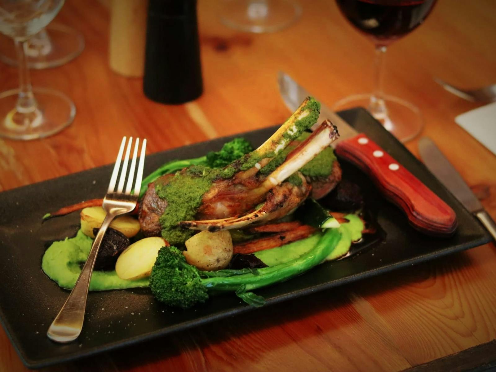 Four Point Tasmanian Lamb Rack on a pea and mint puree with roasted baby root vegetables.