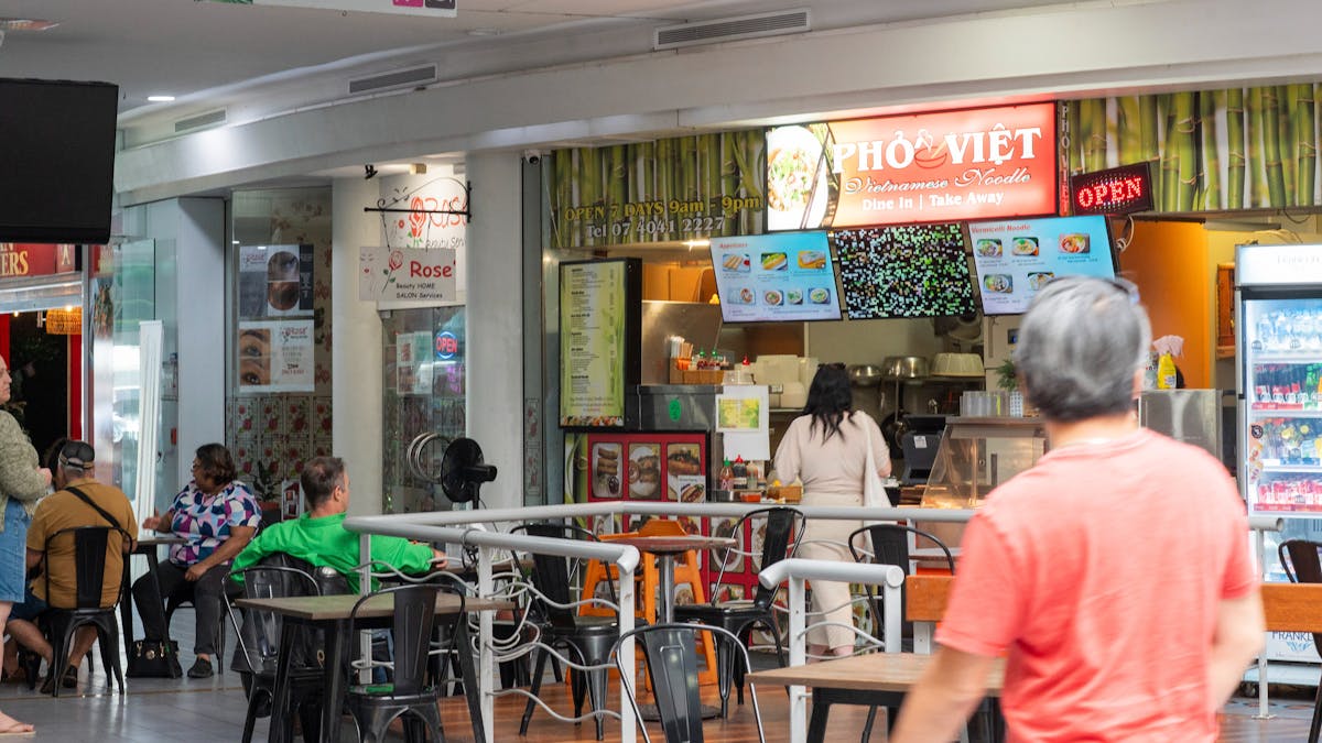 Customers ordering food at Pho Viet and sitting down eating their food