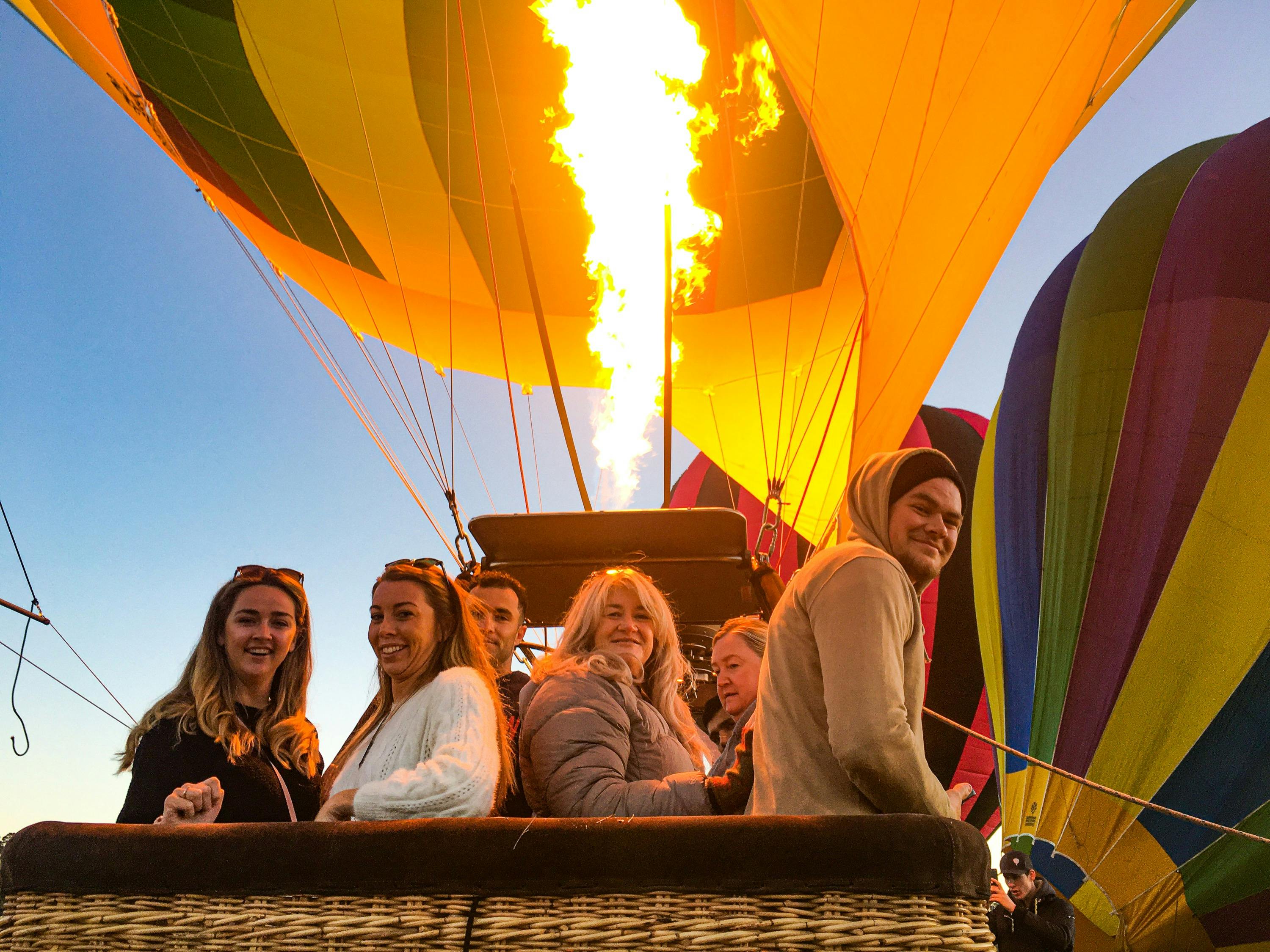 Passengers aboard balloon basket, awaiting launch