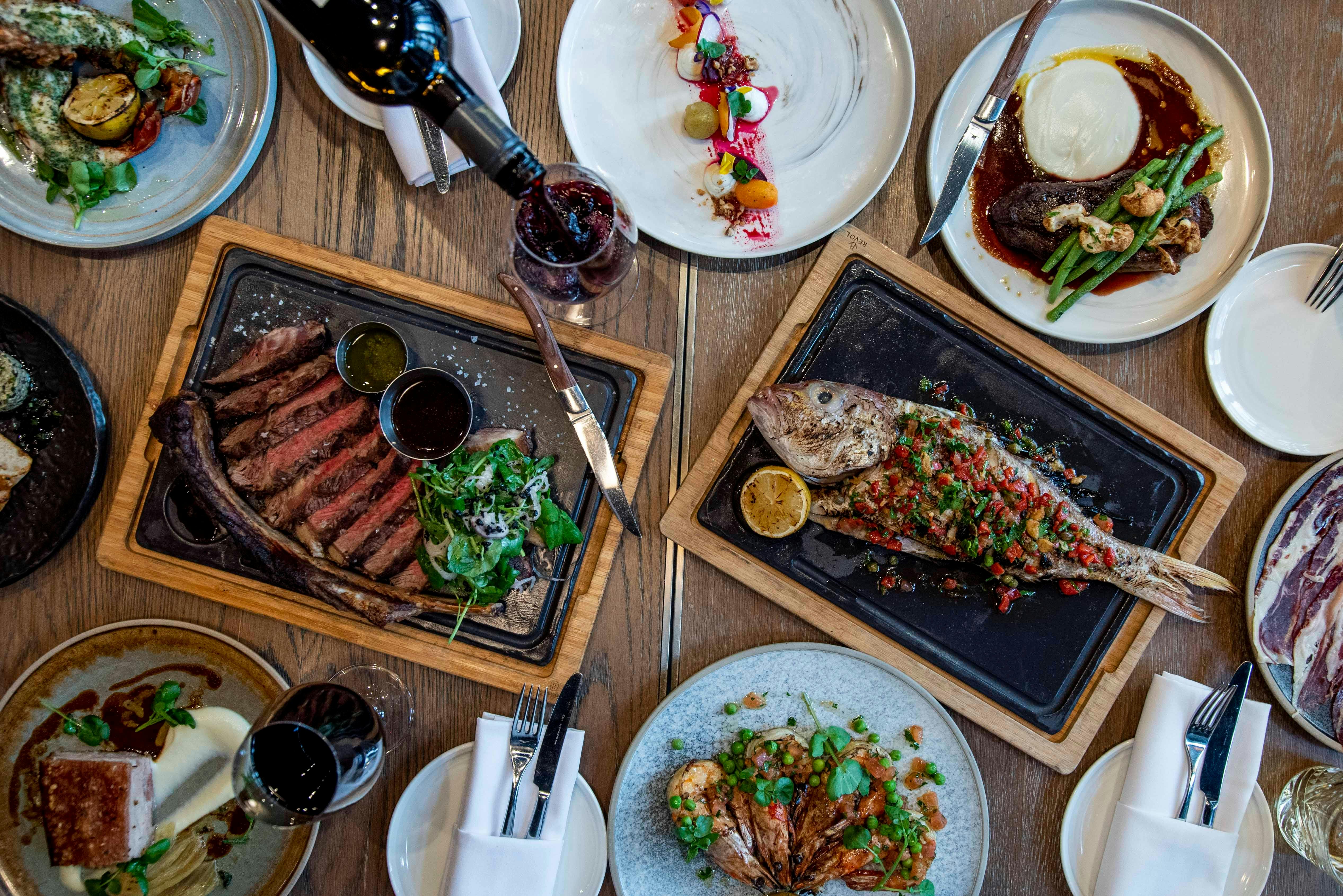 A collection of meat and seafood dishes served at Ascua