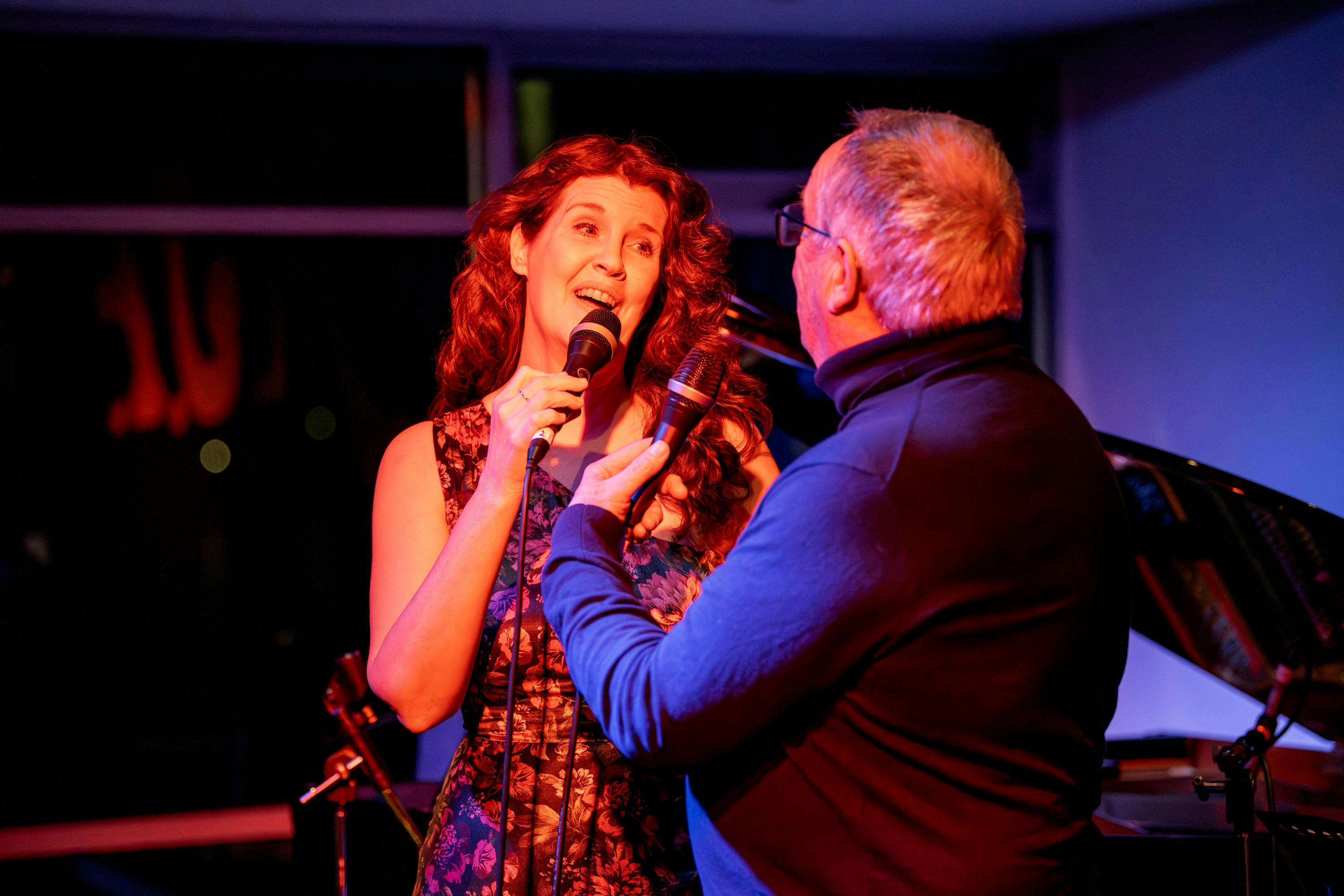 Male and female vocalists perform a duet.